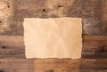 Piece of torn paper on old grunge wood Royalty Free Stock Photo