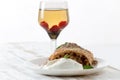 Piece of traditional apple strudel pie served with ice-cream, fresh mint, raspberry and glass of wine Royalty Free Stock Photo