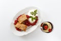 Piece of traditional apple strudel pie served with ice-cream, fresh mint, raspberry and glass of wine Royalty Free Stock Photo