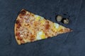 A piece of traditional pizza decorated with a branch of cherry tomatoes on a gray stone background Royalty Free Stock Photo