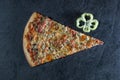 A piece of traditional pizza with decoration from a piece of Bulgarian pepper on a gray stone background Royalty Free Stock Photo