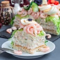 Piece of traditional savory swedish sandwich cake Smorgastorta with a bread, shrimps, eggs, caviar, dill, mayonnaise, cucumber and