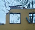 Piece of the wall of ruined house with broken windows, dismantling of building Royalty Free Stock Photo