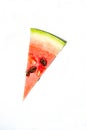 A piece of watermelon cut by a triangle. White background