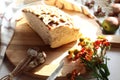 A piece of white bread on a cutting Board with a bouquet of autumn flowers, close-up Royalty Free Stock Photo