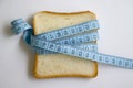 Piece of white bread measuring tape delicious natural a light background