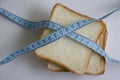 Piece of white bread measuring tape nutrition delicious natural a light background