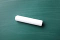 Piece of white chalk on greenboard Royalty Free Stock Photo
