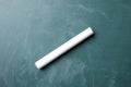 Piece of white chalk on greenboard Royalty Free Stock Photo