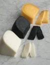 Piece of white goat cheese, black lemon cheese and Gouda cheese