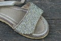 A piece of a white old dirty leather sandal with small rhinestones Royalty Free Stock Photo