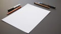 Piece of white paper with a pencil and a pen on it Royalty Free Stock Photo