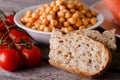 Piece of wholewheat bread with tomatoes and chickpeas