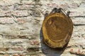 Piece of wood hanging on old brick wall, space for text Royalty Free Stock Photo