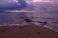 A piece of wood on the sand of Kuta Bali beach at dusk