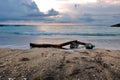 A piece of wood on the sand of Kuta Bali beach at dusk