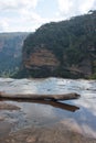 A piece of wood in the water at the top of the Wentworth Falls in the Blue Mountains in Australia Royalty Free Stock Photo