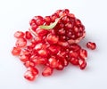 A piece of a young pomegranate with a textured peel and a mountain of beautiful young pomegranate seeds with an elegant fresh pome Royalty Free Stock Photo