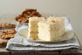 Pieces of apple cake and dried apples on a wooden table. Rustic style.