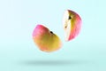 Pieces of an apple in flight on a white background, isolated. Half of aplle in the air