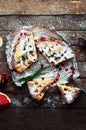 Pieces of apple pie sprinkled with powdered sugar. Top view. Homemade cut apple cake decorated slices of lemon and green spruce br Royalty Free Stock Photo