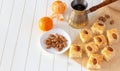 Pieces Basbousa namoora traditional arabic semolina cake with almond nut and syrup, orange and cooper jezva