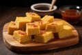 pieces of bbq cornbread arranged on a wooden tray