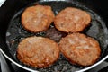 pieces of beef burger being fried on shallow oil on a frying pan, meat burgers cutlet shaped patty made of minced meat Royalty Free Stock Photo