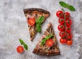 Pieces of black pizza with tomatoes and basil Royalty Free Stock Photo