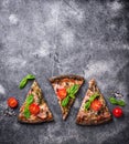 Pieces of black pizza with tomatoes and basil Royalty Free Stock Photo