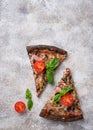 Pieces of black pizza with tomatoes and basil Royalty Free Stock Photo