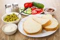 Pieces of bread, green peas, slices of vegetables, sauces, salt Royalty Free Stock Photo