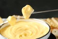 Pieces of bread over pot with delicious cheese fondue Royalty Free Stock Photo