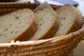 Pieces of bread in wicker basket on wooden table. Royalty Free Stock Photo