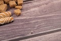 Pieces of brown cane sugar and cookie sticks with chocolate and white icing on a wooden background. Close up Royalty Free Stock Photo