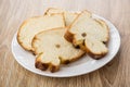 Pieces of bun with raisin in white plate on table Royalty Free Stock Photo