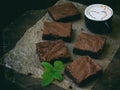 Pieces of cake chocolate brownies on wooden background. Royalty Free Stock Photo