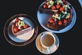 Pieces of cake. Drink hot chocolate cocoa coffee in cups. Black background. Royalty Free Stock Photo