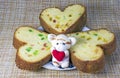 Pieces of cake in the shape of hearts and a soft toy with a heart Royalty Free Stock Photo