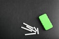 Pieces of chalk and duster on blackboard Royalty Free Stock Photo