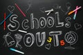 Pieces of chalk, stationery and text SCHOOL`S OUT written on blackboard. Summer holidays Royalty Free Stock Photo