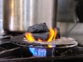 Pieces of charcoal on the fire in a restaurant kitchen