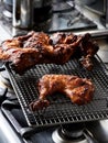 Spiced charcoal grilled chicken legs on a metal rack Royalty Free Stock Photo