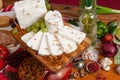 Pieces of cheese on a knife board