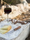 Pieces of cheese and raisins with a red wine glass on a old wood Royalty Free Stock Photo