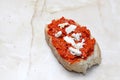 Pieces of a cheese on traditional macedonian food ayvar smeared on a bread .homemade product