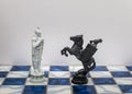 A pieces of chess character on the board with a light. A character represents strategy, planning, brave, betrayal, confrontation a