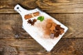 Pieces of chocolate, cinnamon, mint and star anise on a cutting Board. Royalty Free Stock Photo