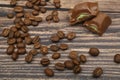Pieces of chocolate and coffee beans on a wooden background. Close up Royalty Free Stock Photo