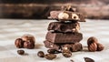 pieces of chocolate with hazelnuts and coffee beans on a brown tablecloth